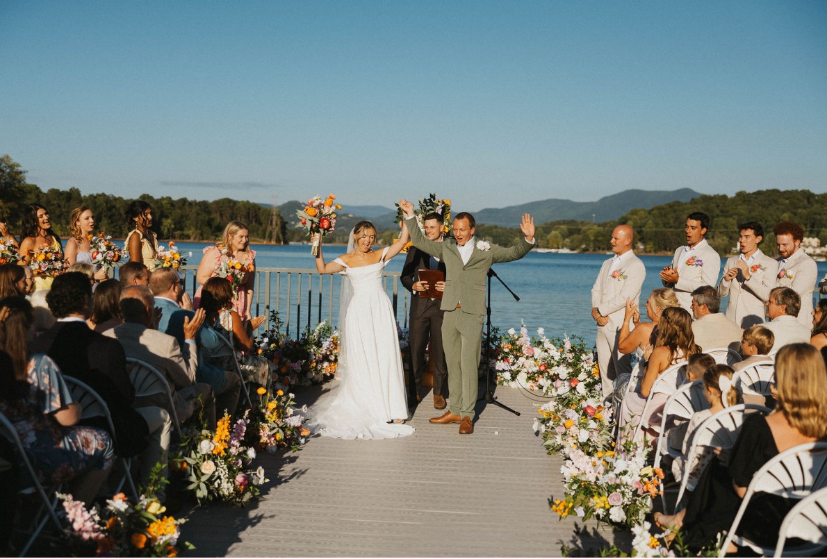 "Bride and groom celebrating at lakeside wedding ceremony on Lake Chatuge at The Ridges Resort in Hiawassee, North Georgia."